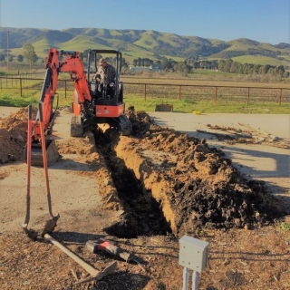 Miguel excavating trench